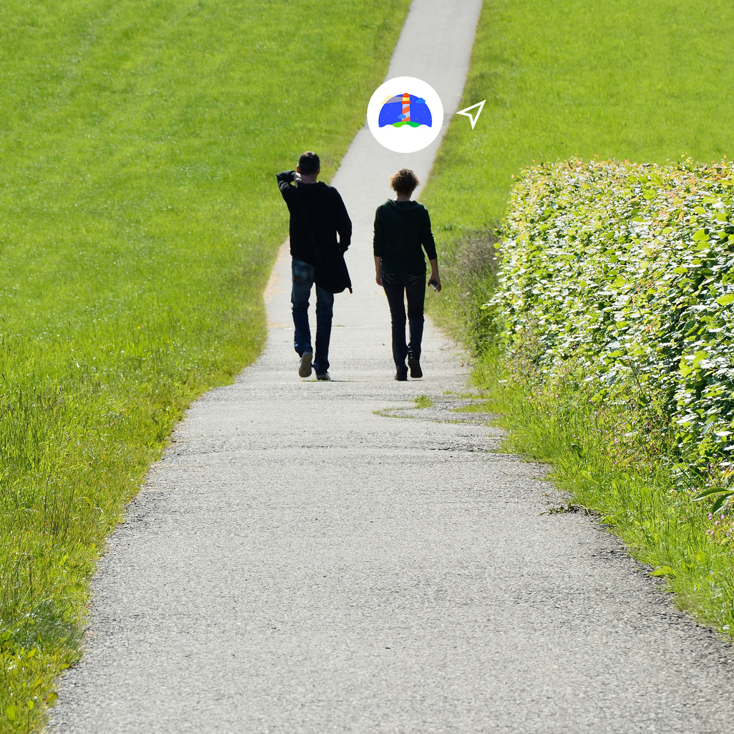 Two people walking in a lane in the grass field with Beacon.