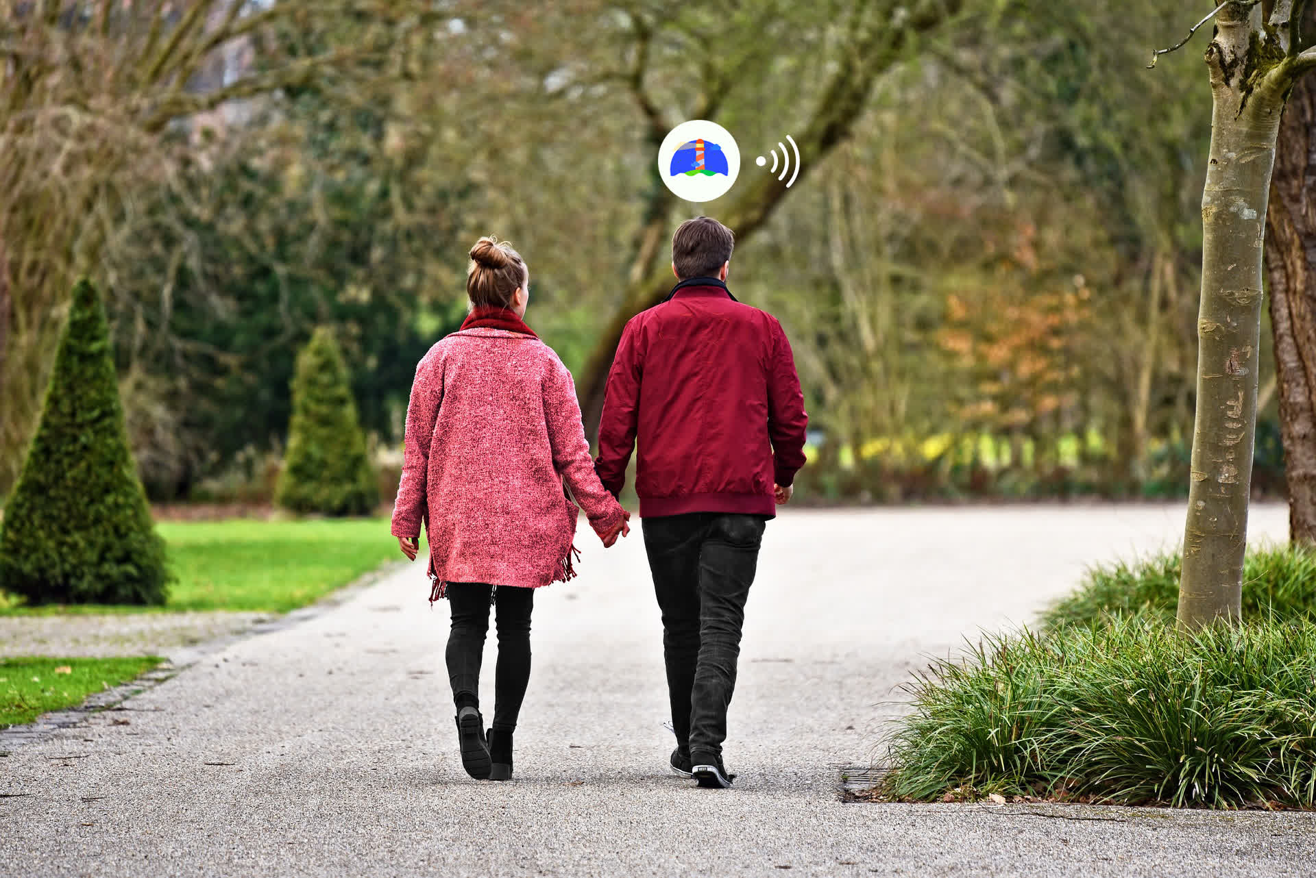 Two people walking in the park using Beacon.